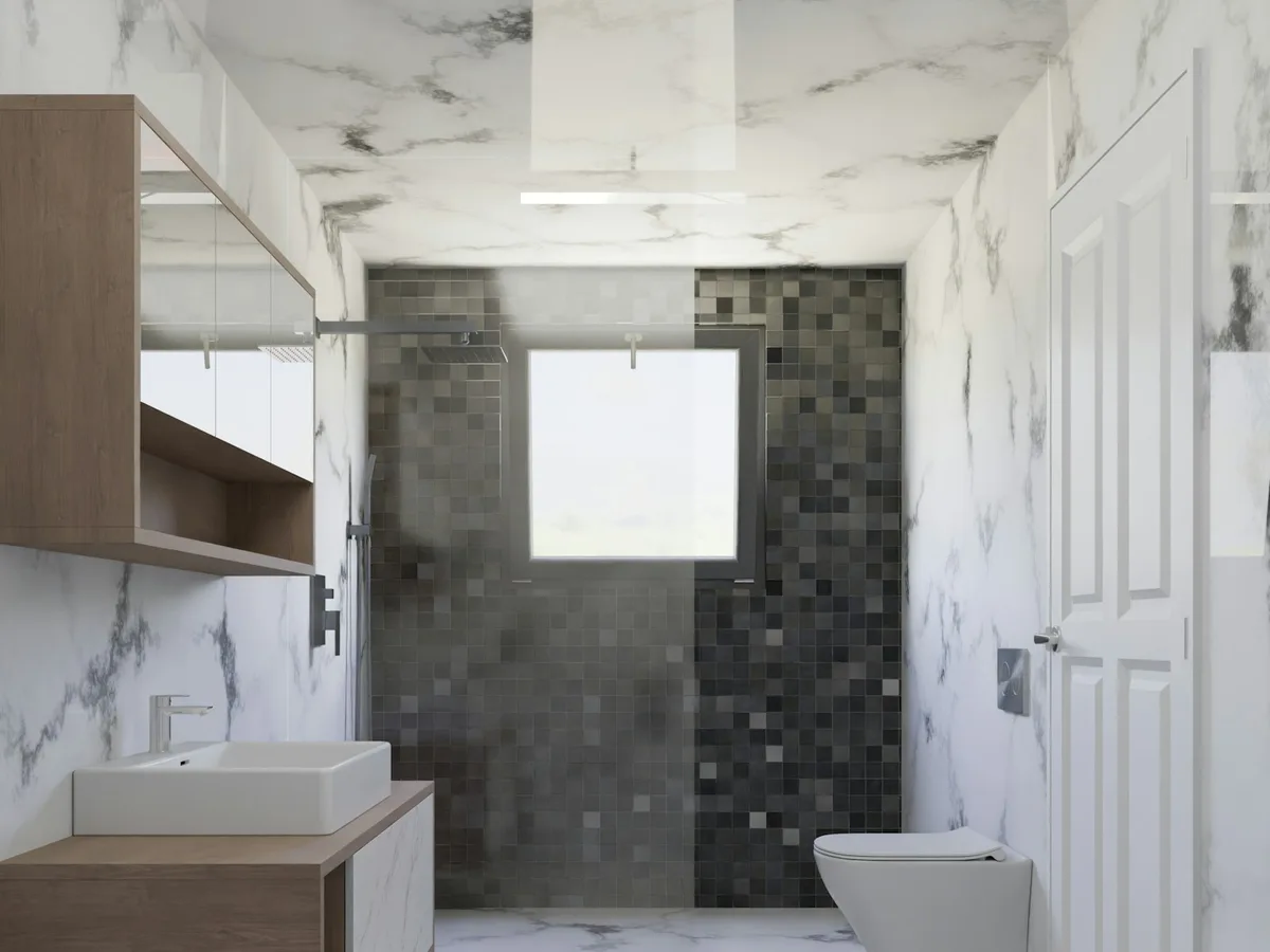 Bagno finito con rivestimento marmo, mosaico scuro e mobile lavabo
